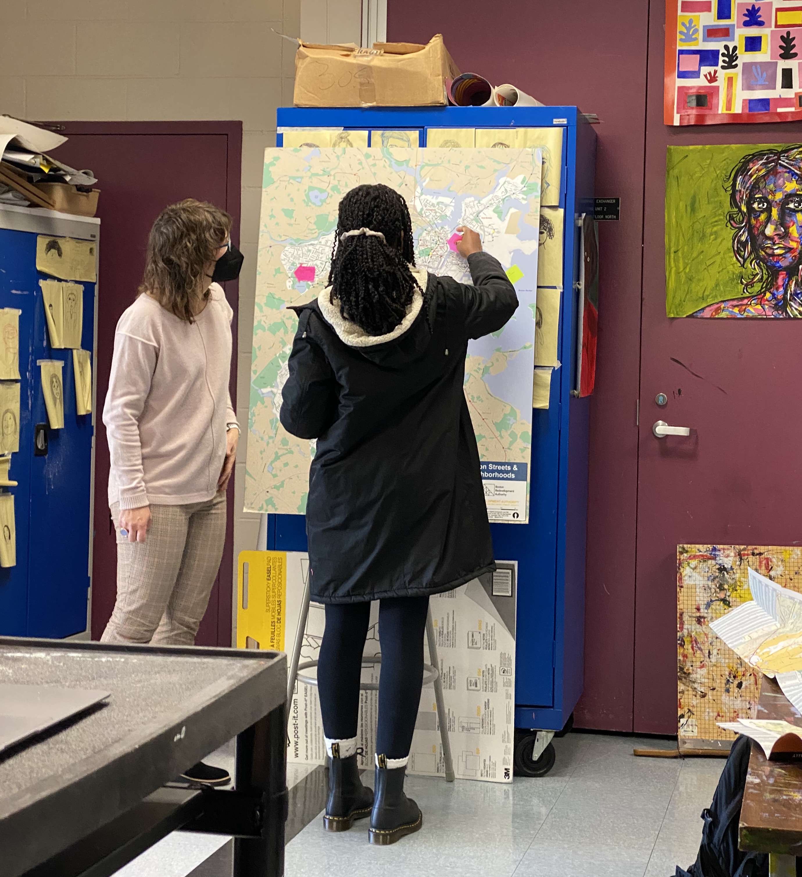 LMEC Director of Education Michelle LeBlanc stands with Margarita Muñiz Academy student while labeling a blank map of Boston.