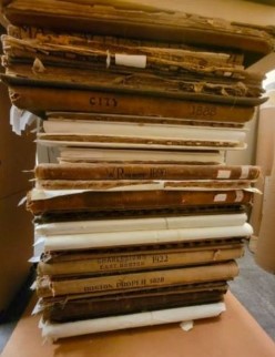 A stack of some of the urban atlases in LMEC&rsquo;s collection, also demonstrating their often fragile conservation status.